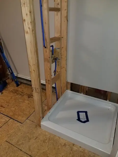 Shower base and wall framing during bathroom renovation